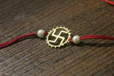 The Swastika is the sign of well-being, good luck, and prosperity. This beautifully crafted Rakhi with striking gold not only signifies power and profess but also look extremely stylish.     Let all the good luck come your brother's way with this stunning Swastika Rakhi.